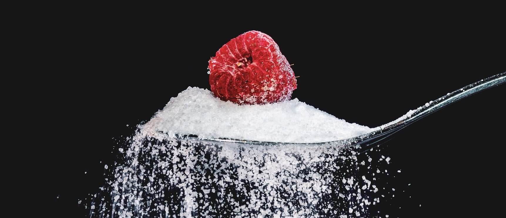 sugar on a spoon with a raspberry on top - sugar allergy